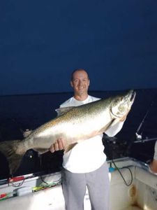 Angler proudly holding a Rainbow Trout fish in NY