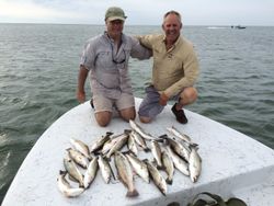 Two people fishing on a Texas shore