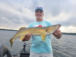 A fisherman with a large fish caught in Boulder Junction