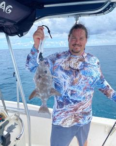 Angler holding a 14-inch fish in FL