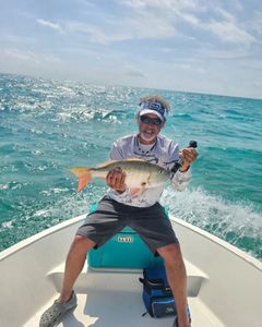 one fisherman catching a 19-inch fish in key largo