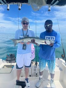 Two people fishing in Florida with a single catch