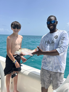 Reeling in a Mutton Snapper on a partly cloudy day in Key Largo!