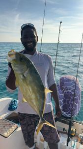 Proud angler displays his prized catch on the open waters, radiating joy and the thrill of the sport.