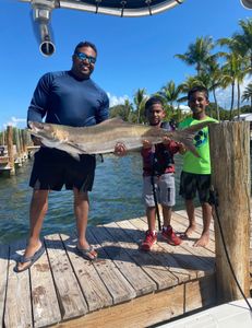 Three people fishing with one big fish caught in FL