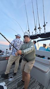 Three people fishing on the shores of MI