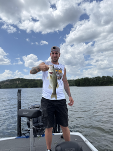 Reeling in a Florida Bass at Buchanan Dam under partly cloudy skies!