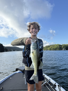 Reeling in a huge Largemouth Bass at Buchanan Dam under clear skies!