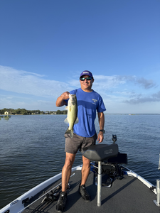 Reeling in a 16-inch Largemouth Bass under partly cloudy skies!