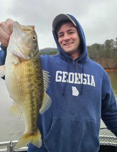 A fisherman holding a 25-inch fish in GA
