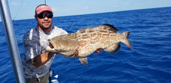 Angler with a large black grouper fish caught on Stock Island
