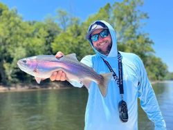 Angler with a rainbow trout in Missouri