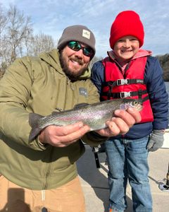 A rainbow trout caught by two people in Branson