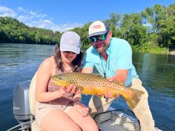 A fisherman holding a sea trout in MO