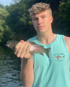 Angler holding a rainbow trout in MO