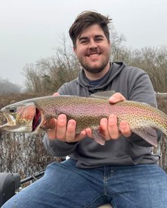 Angler holding a large rainbow trout in Branson