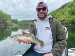 A fisherman holding a sea trout catch in Branson
