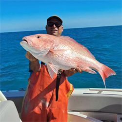 Fisherman holding a 27-inch fish in FL