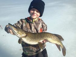 Proud angler with a large Northern Pike fish caught in Phelps