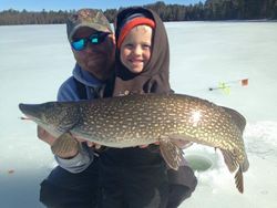 Angler holding a large northern pike caught in WI