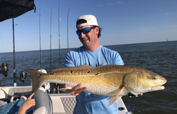 Two anglers fishing in the Gulf Shores waters