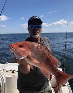 A person fishing in the Gulf Shores