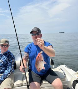 Two people fishing in the Gulf Shores