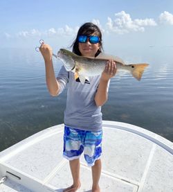 A lone fisherman catching a fish in TX