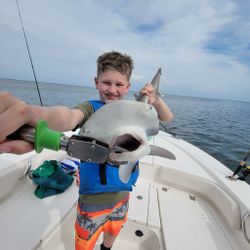 One fisherman holding his catch in St. Petersburg