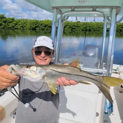 A fisherman holding a large snook in St. Petersburg