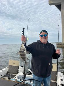 Angler with a black drum fish in Pass Christian