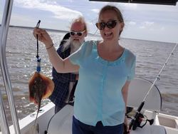 Two people fishing with rod and reel in Savannah