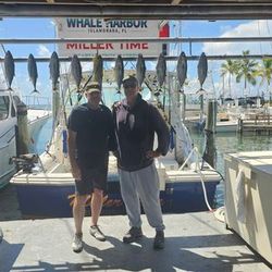 Two anglers fishing in Islamorada with a 13-inch catch