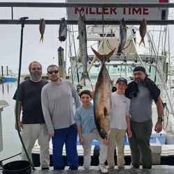 Fishing charter catch display in Islamorada FL featuring Greater Amberjack, Great Barracuda, Atlantic Bonito, and Skipjack Tuna hanging at marina dock