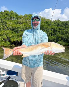 A single fisherman enjoying the scenic views of Holmes Beach while on a fishing tour.
