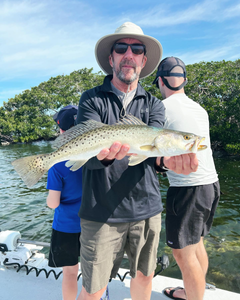 Angler holding a spotted weakfish, 23 inches long, in FL