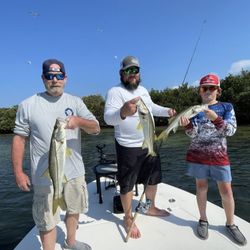 Three anglers displaying caught snook on fishing boat in Palmetto FL waters