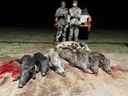 Two hunters posing with their catch in Archer City