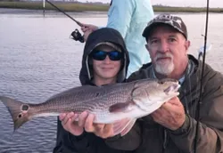 Angler holding a large redfish in Jacksonville