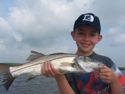 A person holding a 19-inch snook fish in Jacksonville, Florida