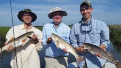 Three fishermen with their catch in Jacksonville