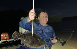 Angler holding a southern flounder fish caught in Tampa, Florida
