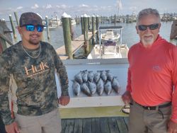 Two people fishing in the waters of Gulf Shores