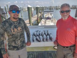 Two people fishing on the Gulf Shores beach