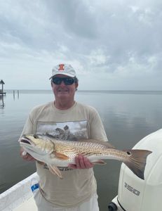 A person fishing for a large redfish in AL