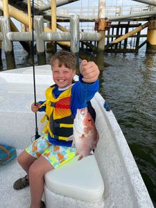 Lone angler fishing in the waters of Gulf Shores