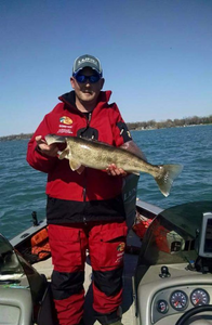 Angler holding a 24-inch fish in MI