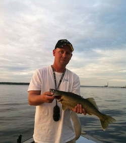 A lone fisherman casting a line in Muskegon