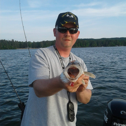 A single fisherman in Muskegon catching a 7-inch fish while fishing