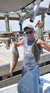 Two summer flounder, 18 inches long, caught while fishing in Corpus Christi